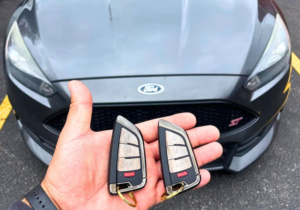 Austin Snap Keys in Austin, Texas provides professional Ford key fob replacement, smart key programming, and car key duplication services. Image shows two newly programmed Ford smart keys in front of a Ford vehicle. Mobile auto locksmith service available for lost keys, spare keys, and emergency lockout assistance throughout Austin